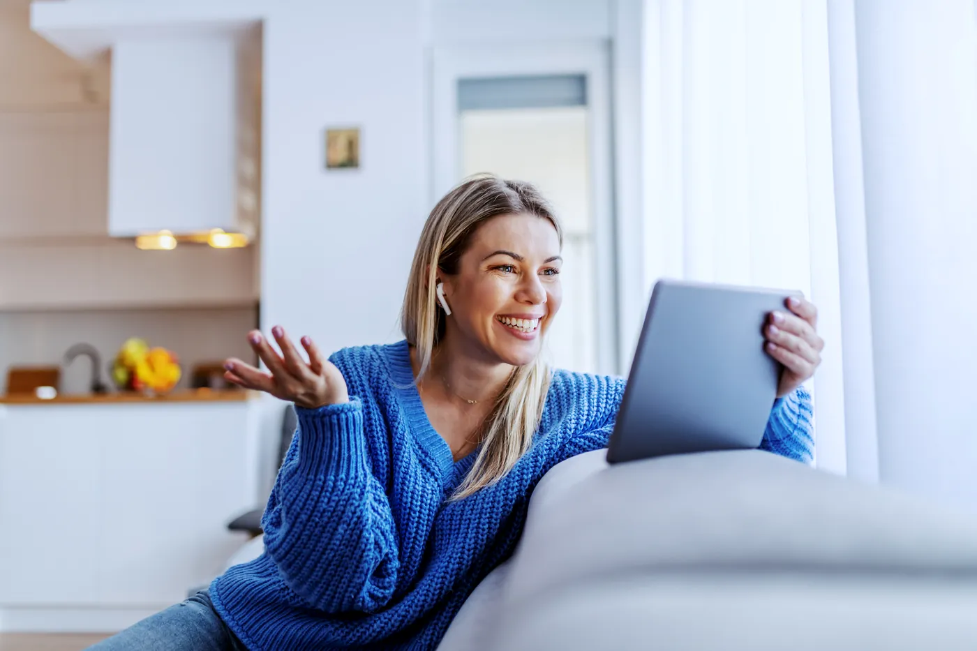A woman joining a live viewing on a tablet