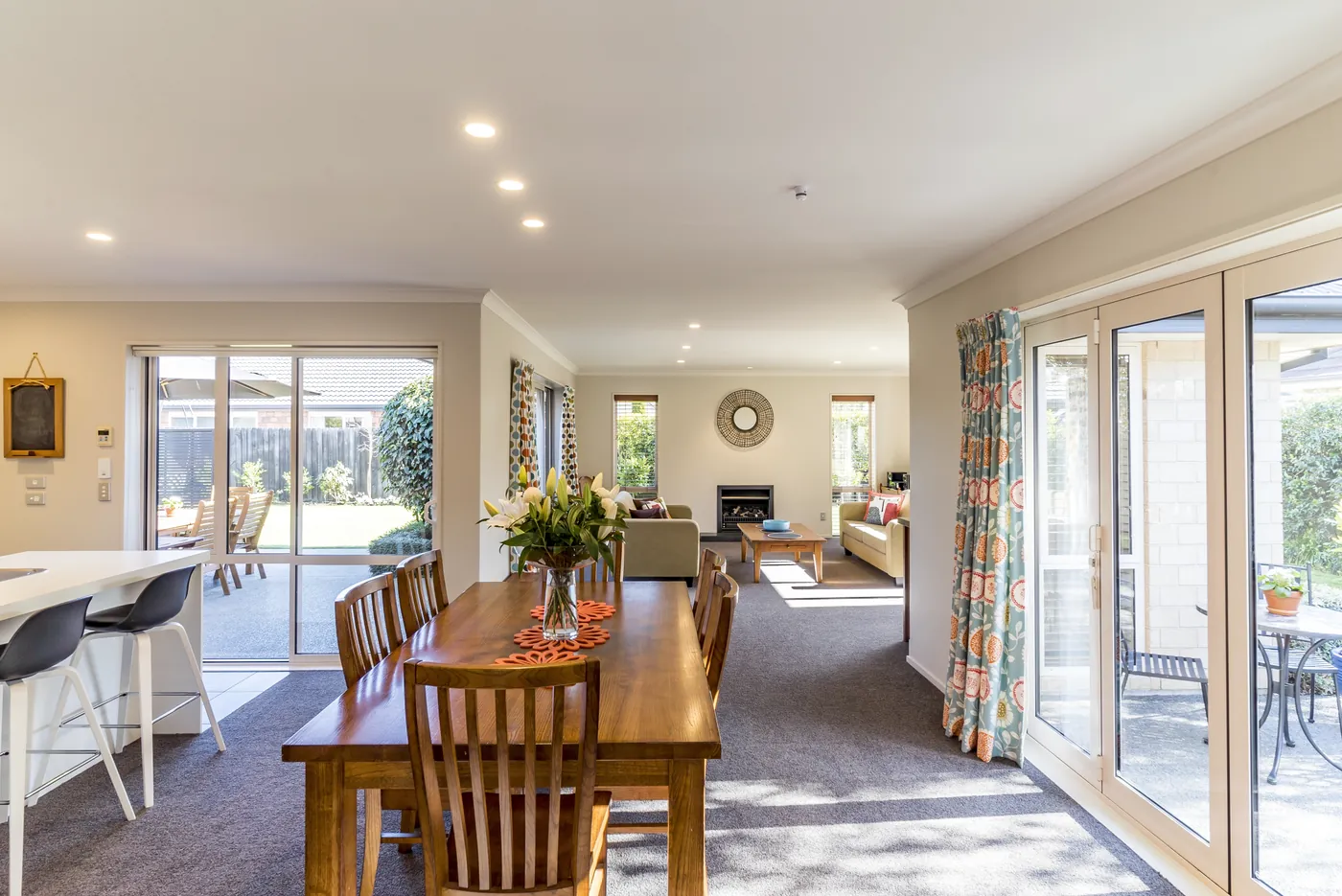 An open-plan dining and living room with sliding doors to the garden