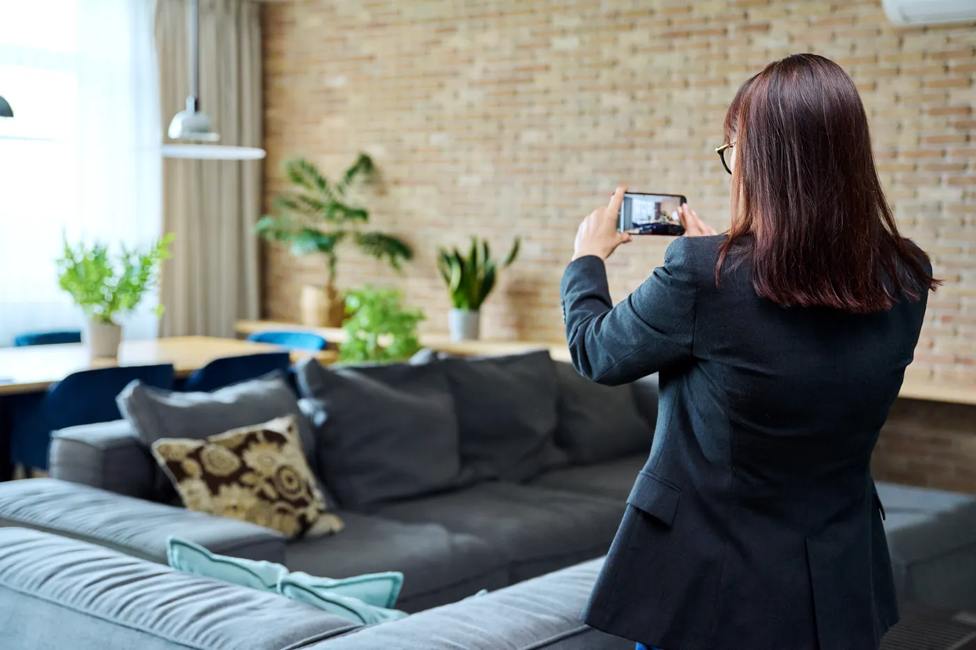 A woman photographing a furnished room