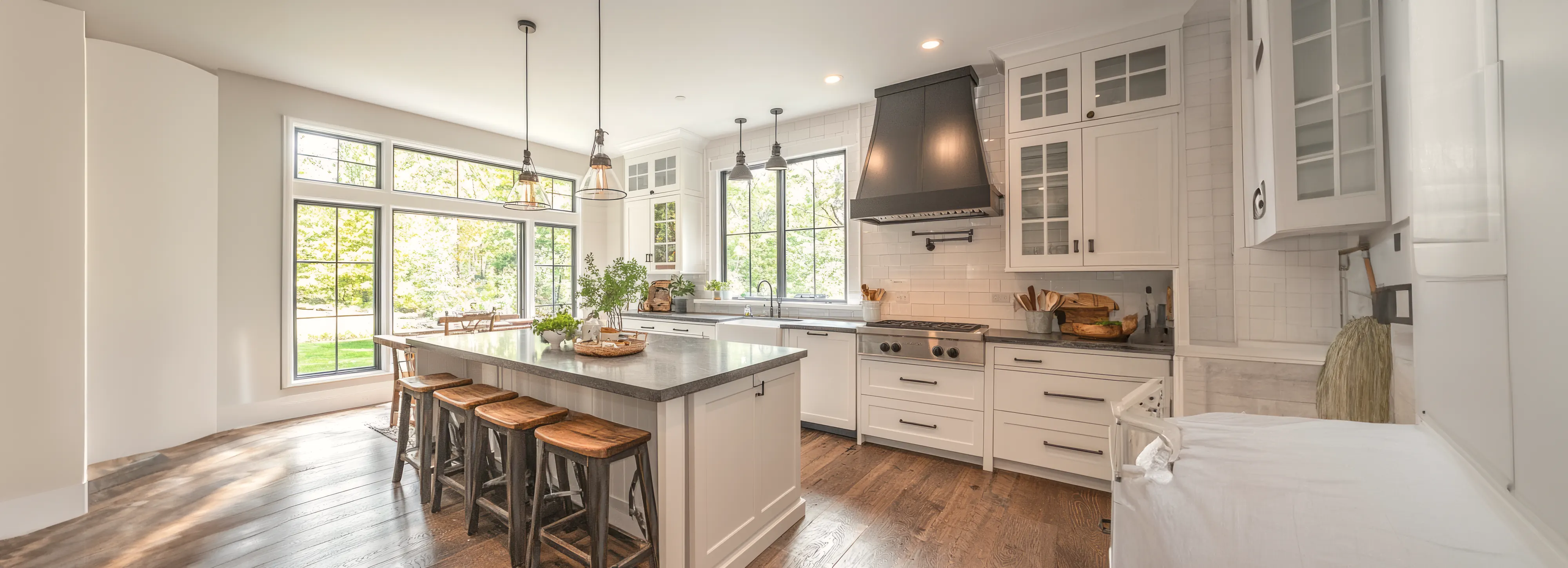 Wide panorama of a light-filled farmhouse kitchen